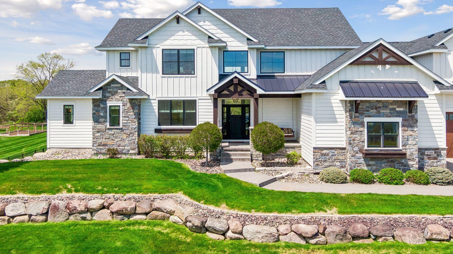 The landscaping is one of a kind with stone stairways and boulder retaining walls.
