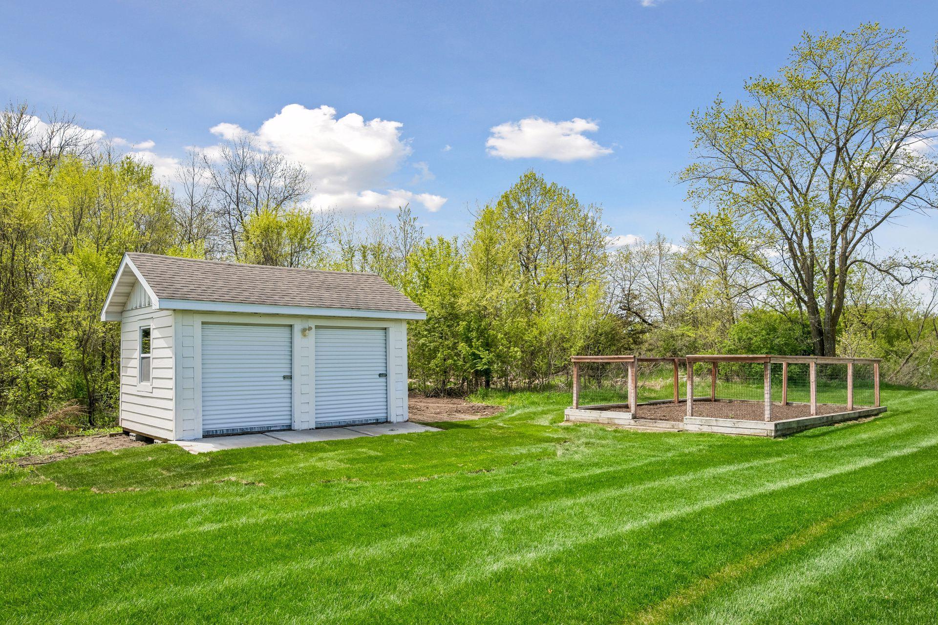 Storage shed and fenced in garden beds.