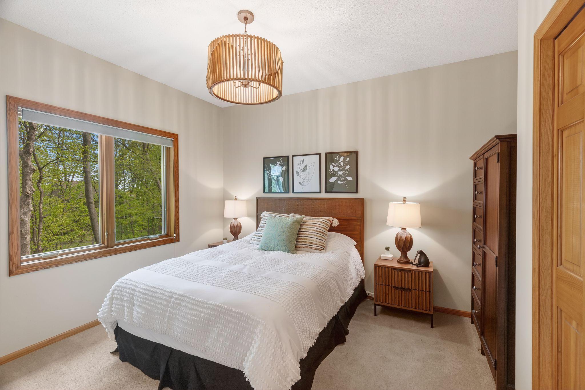 Main-level guest suite offers exceptional flexibility with a ¾ bath and pocket door separation—ideal for guests, multigenerational living, or a second office!