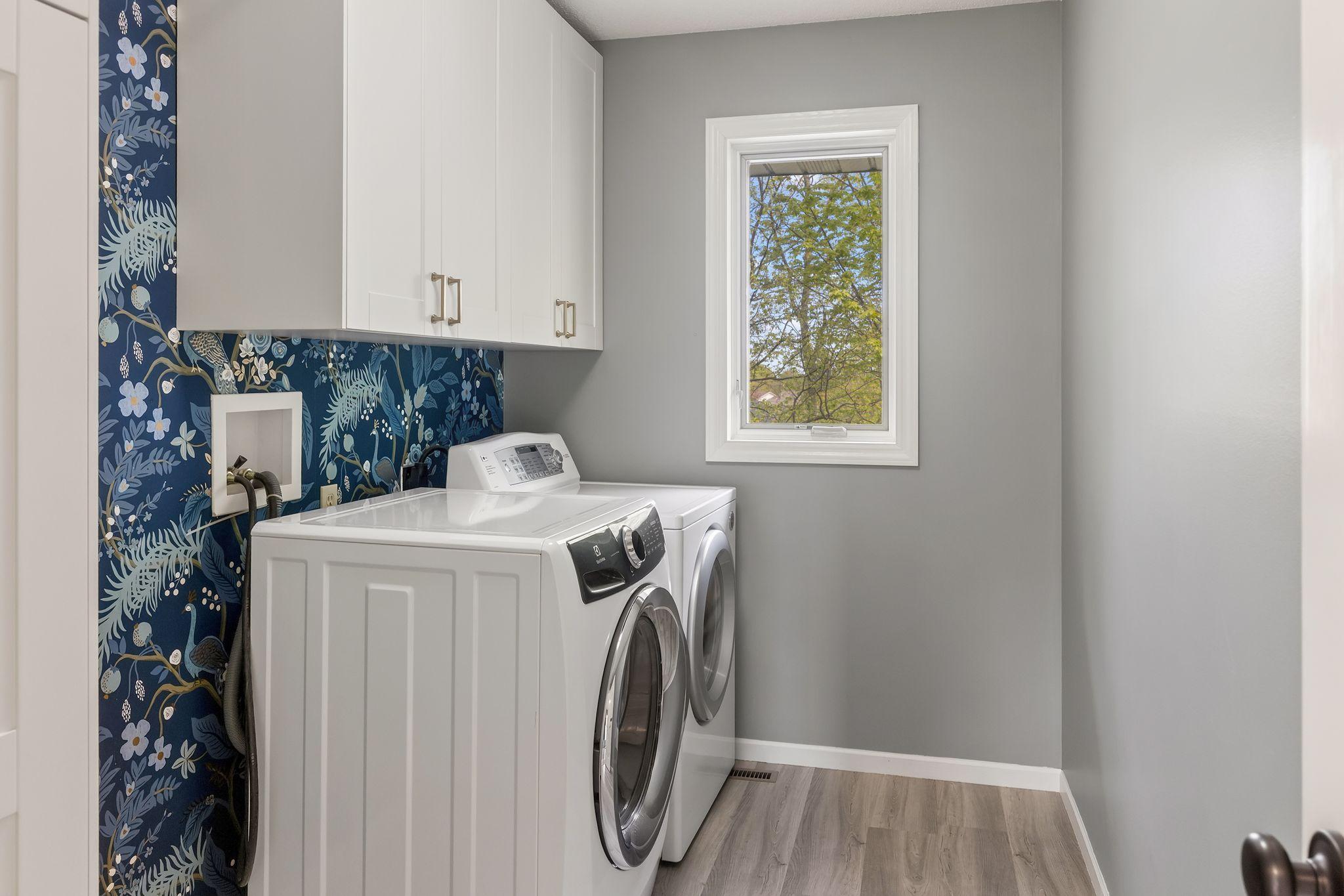 Upper level laundry with built-in cabinetry