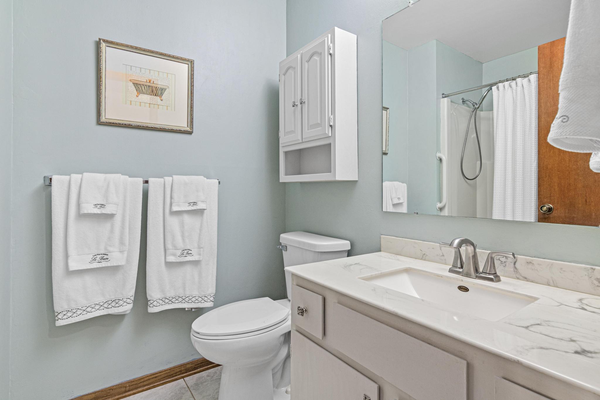 The bathroom has been updated too! It features updated tile floor, a new sink and faucet, newer toilet and light fixture.