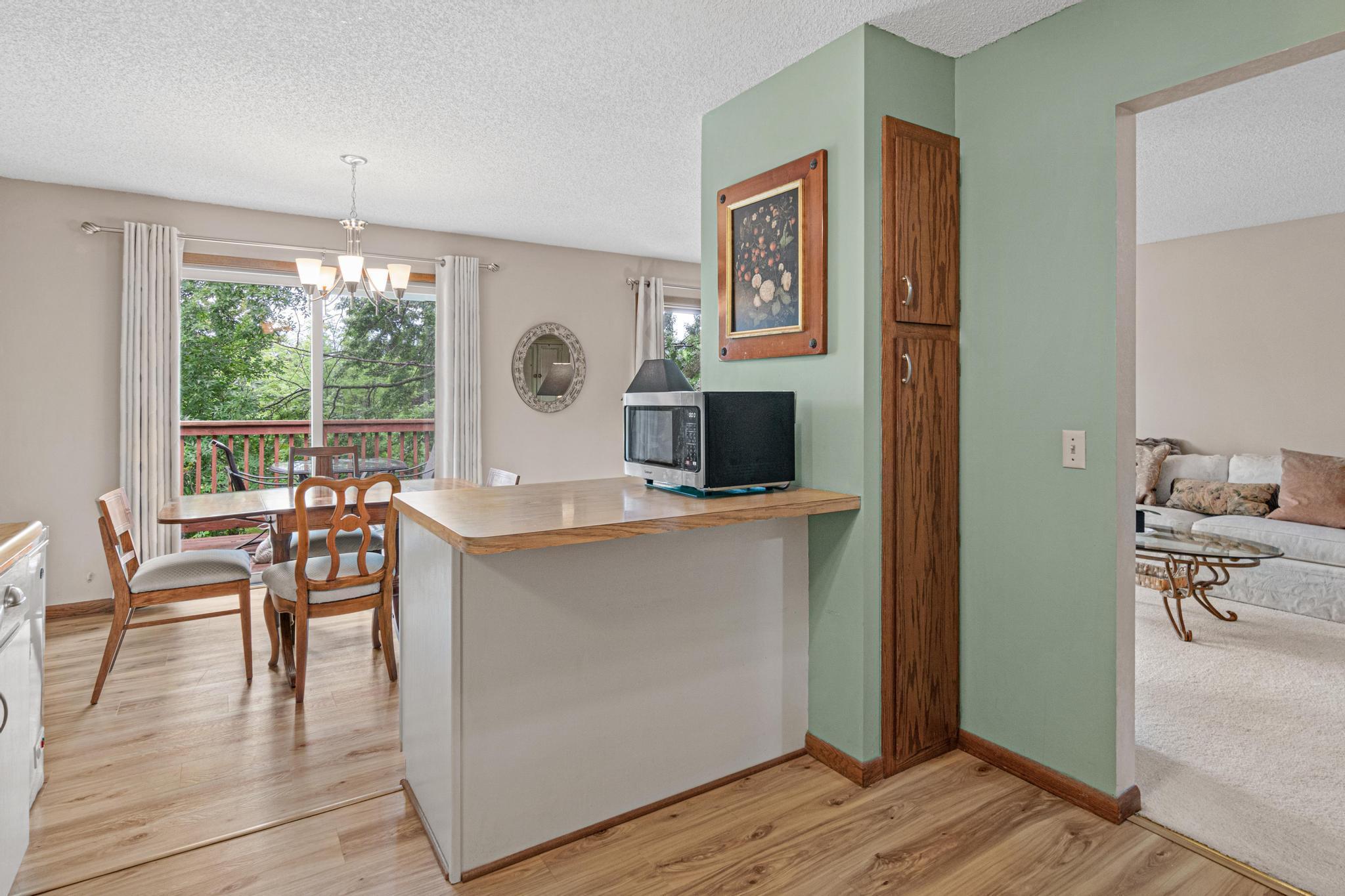 Alternate view of kitchen shows the open view to the dining room and the deck.