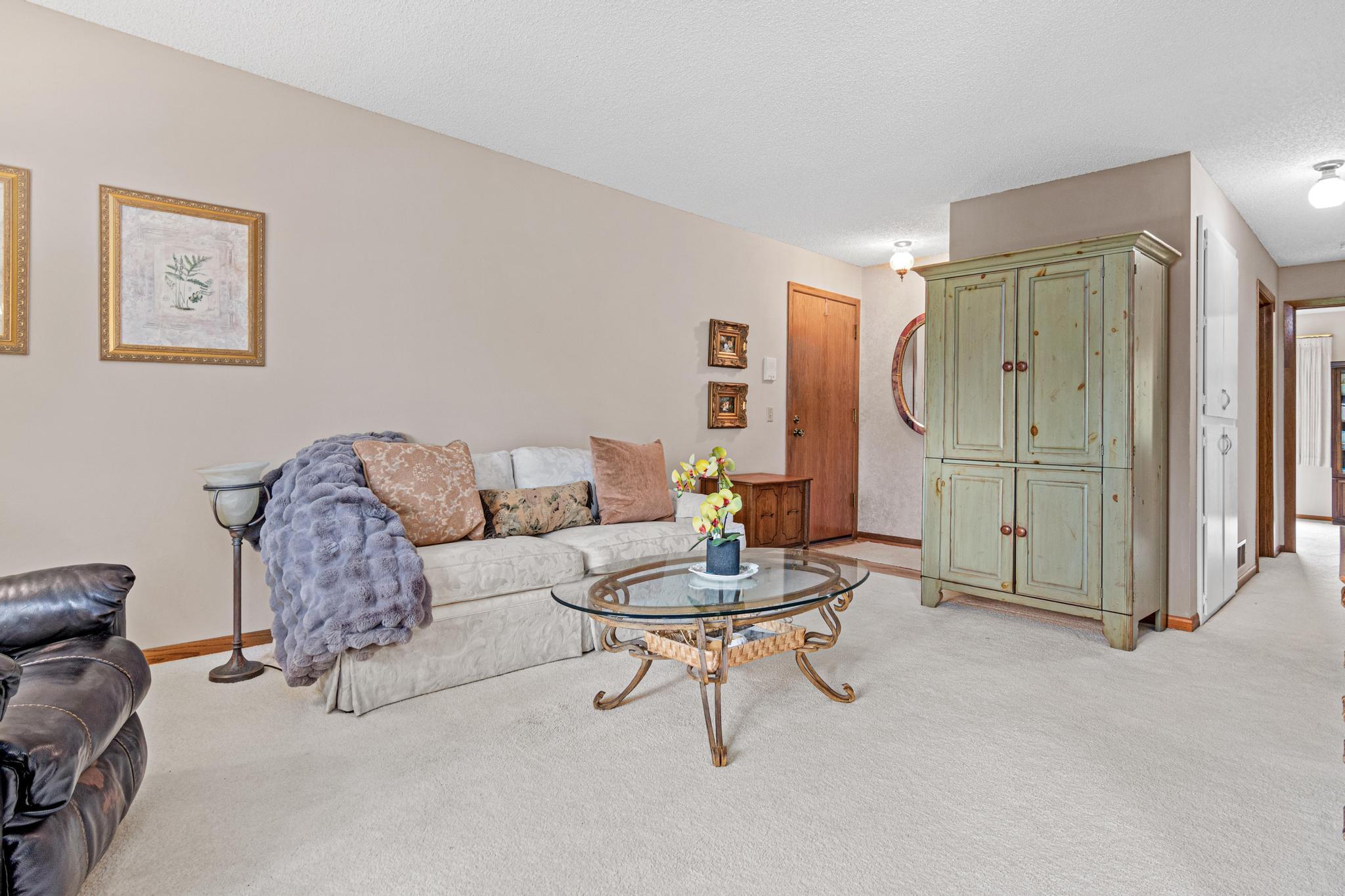 The entryway has the same vinyl flooring as the kitchen and dining room and a large entry closet.