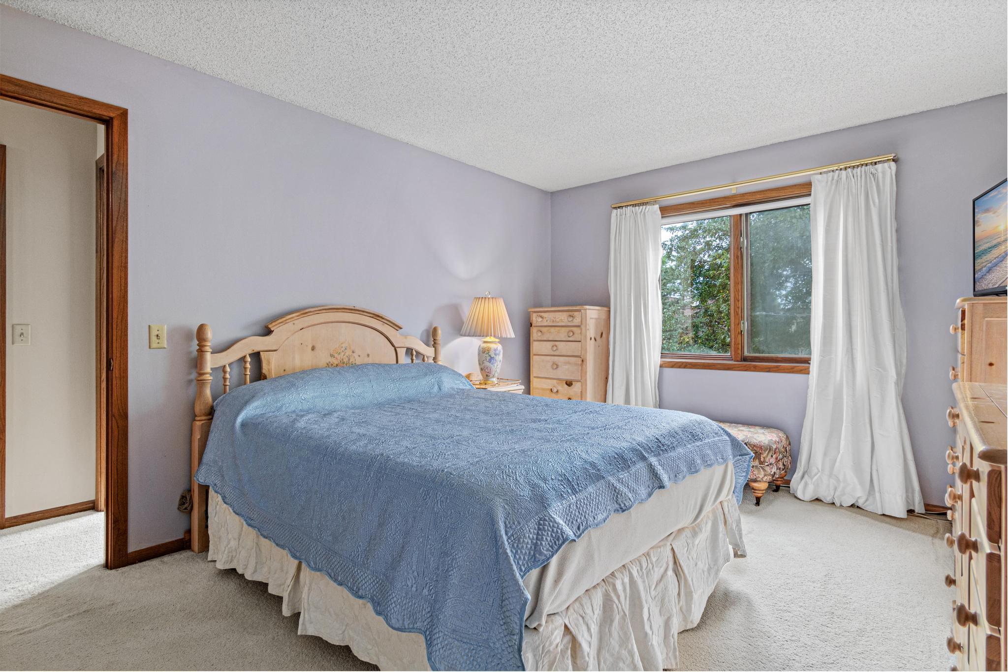 The primary bedroom is spacious and has a walk-in closet.