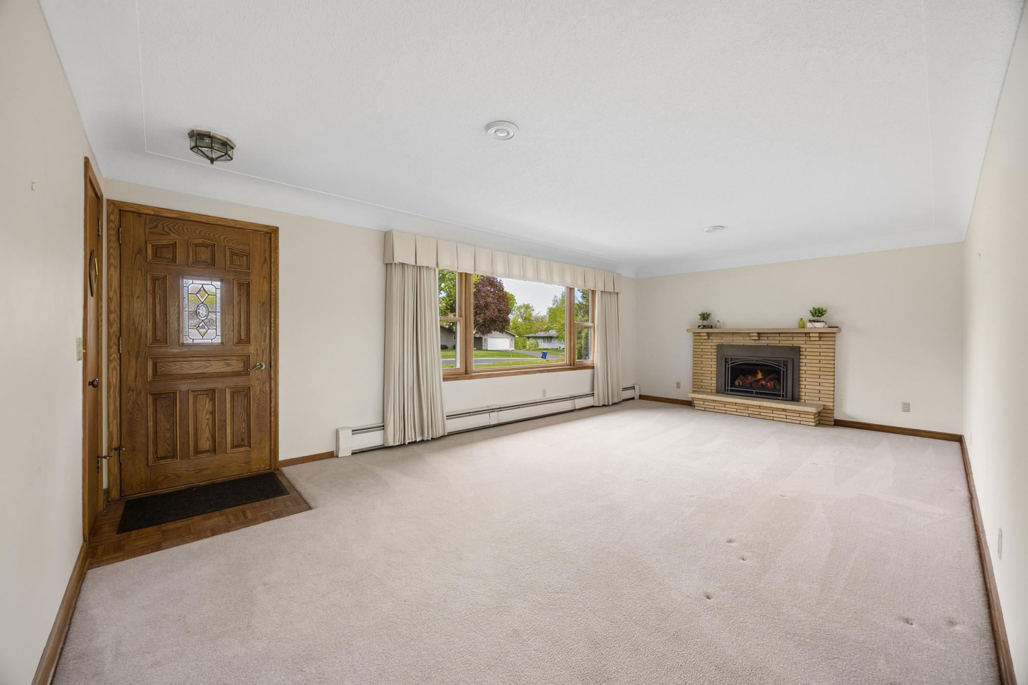Beautiful front entry paired with an expansive picture window overlooking the lush, landscaped front yard.