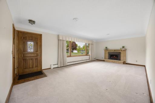 Beautiful front entry paired with an expansive picture window overlooking the lush, landscaped front yard.