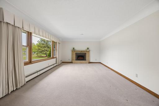 Brick surround fire place and soft carpeting add to the ambiance of this room.