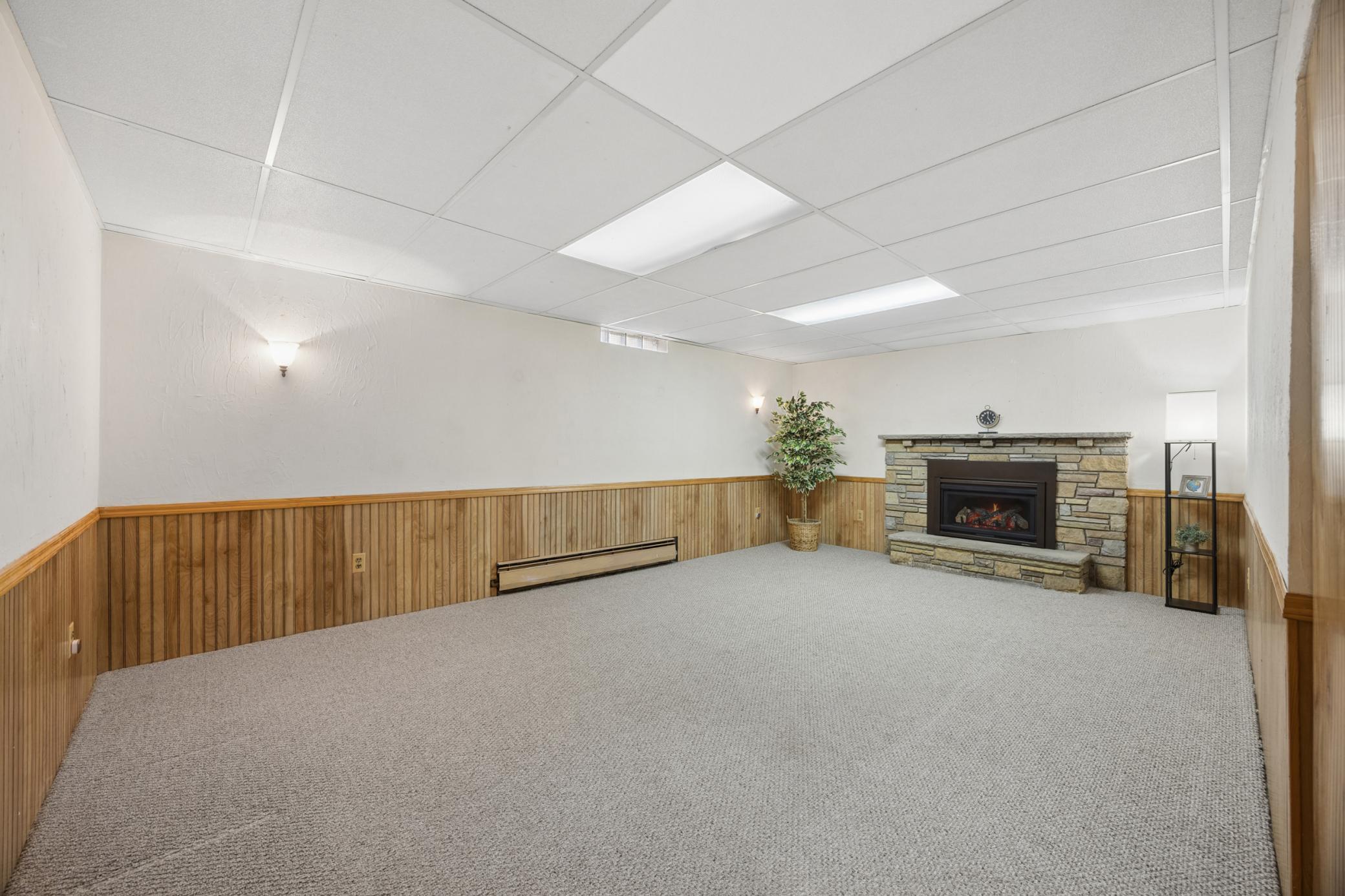 Lower level also includes a nice brick surround fireplace.