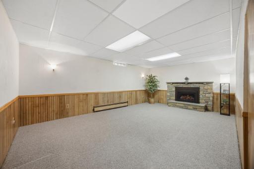 Lower level also includes a nice brick surround fireplace.