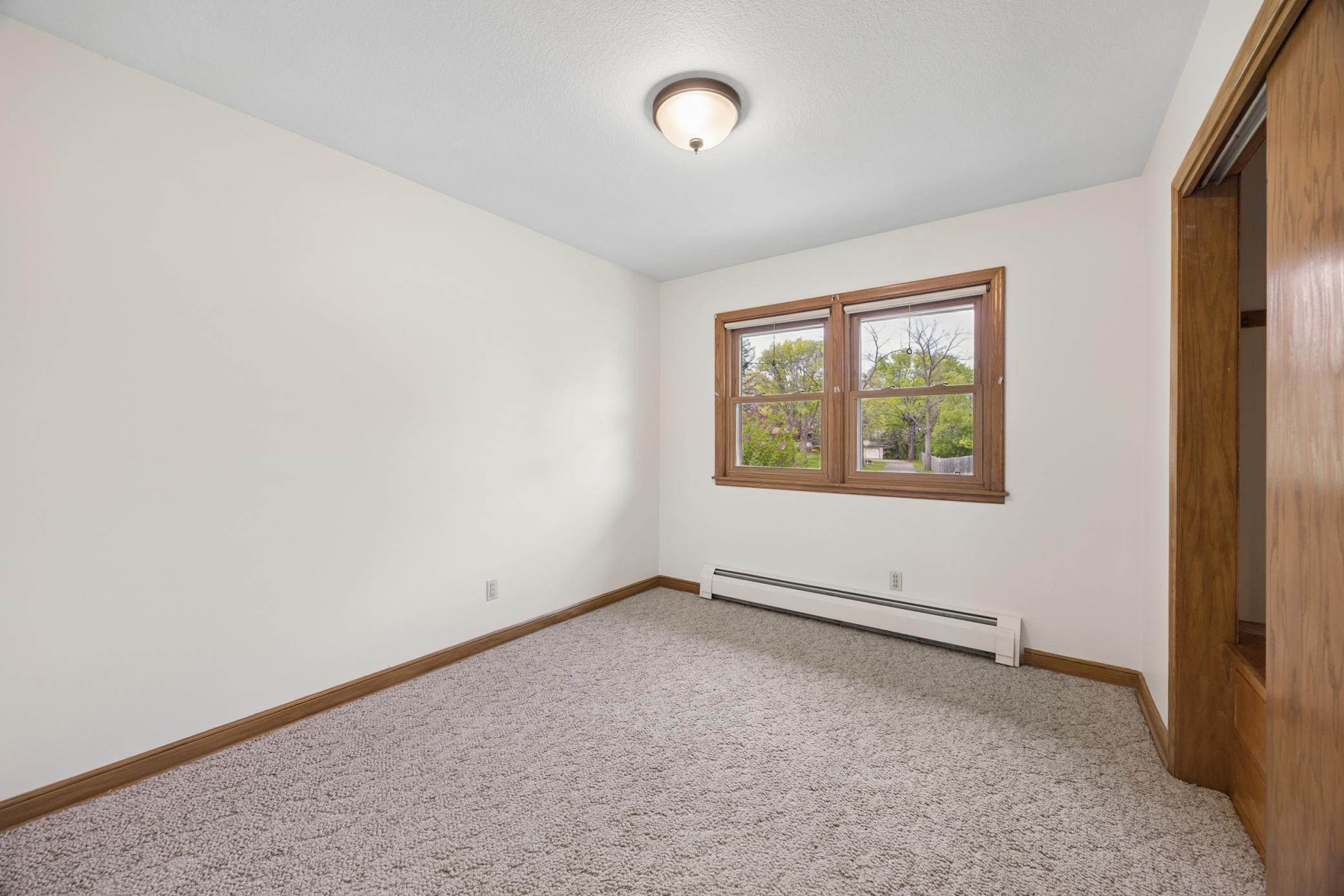 3rd bedroom overlooks the front yard and has a large closet with built-in storage.