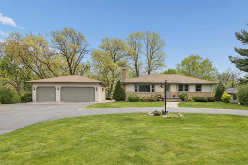 A rare 3-car garage offers exceptional storage and functionality, with ample additional space for guest parking.