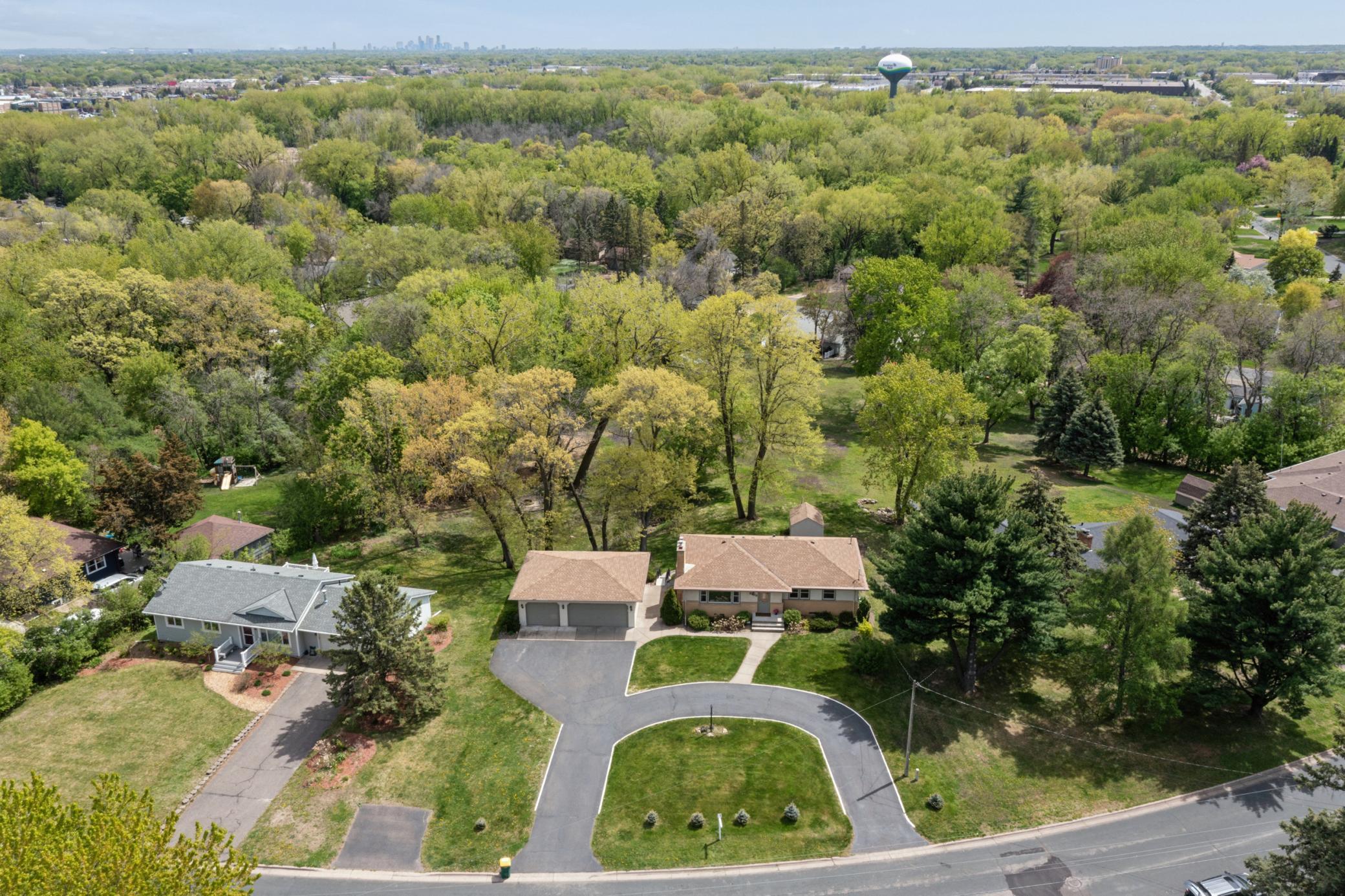 A nature lover’s dream with scenic surroundings. This gorgeous lot featuring mature landscaping, impressive circular drive, open green space, and a peaceful country-like feel close to the city.