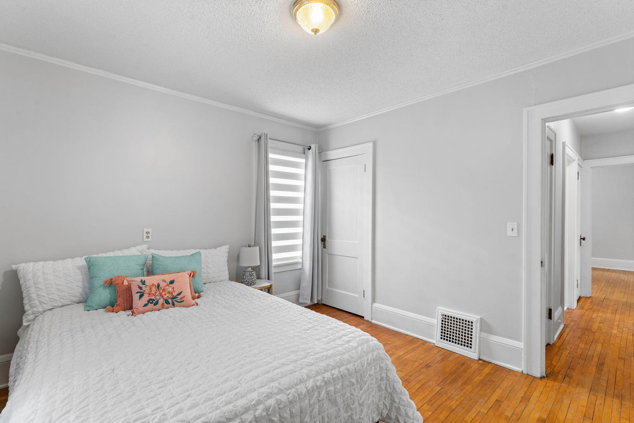 First of the two of the spacious main level bedrooms with hardwood floors and new room darkening shades.