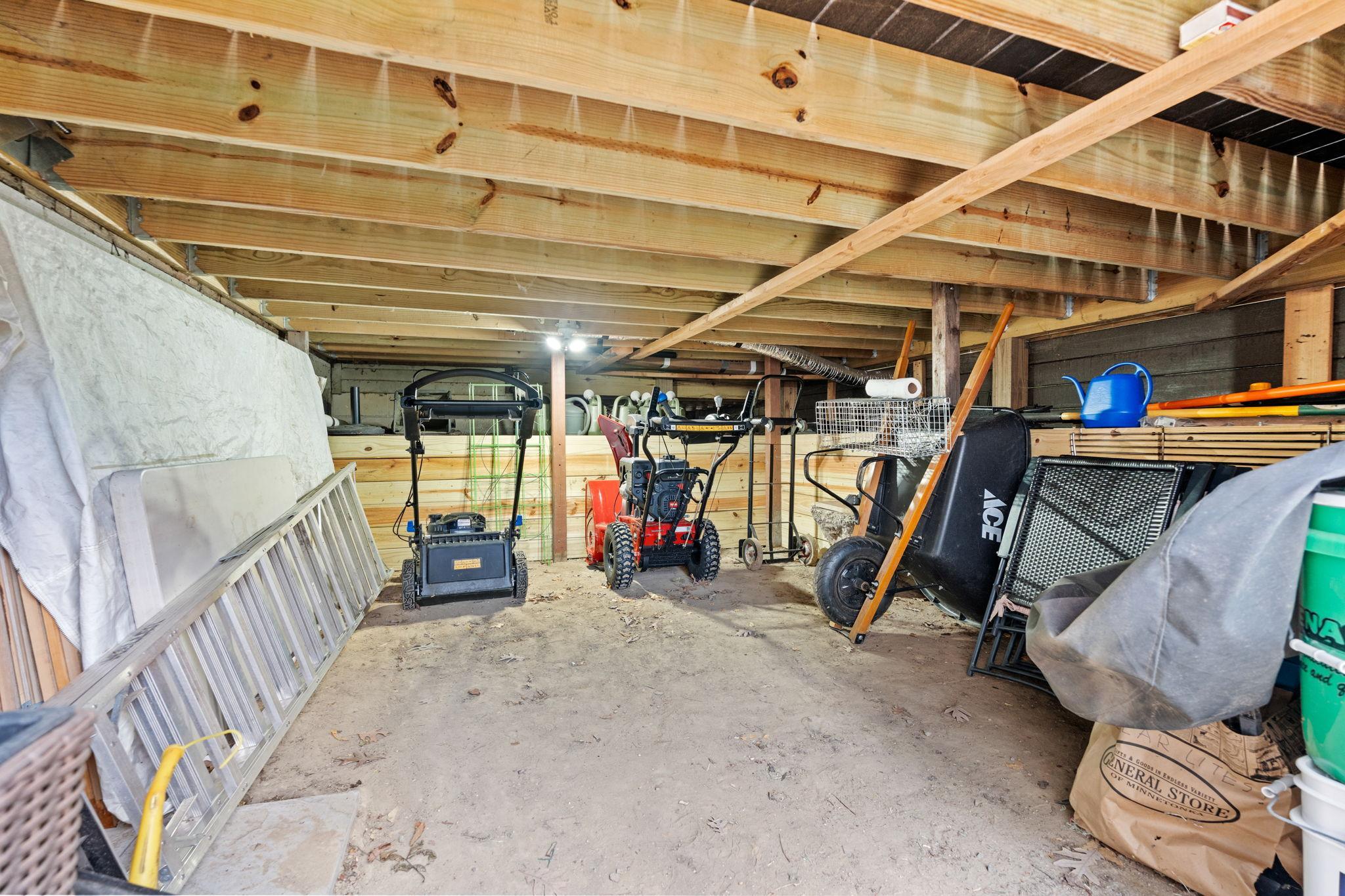 Under porch storage for lawn tools and furniture