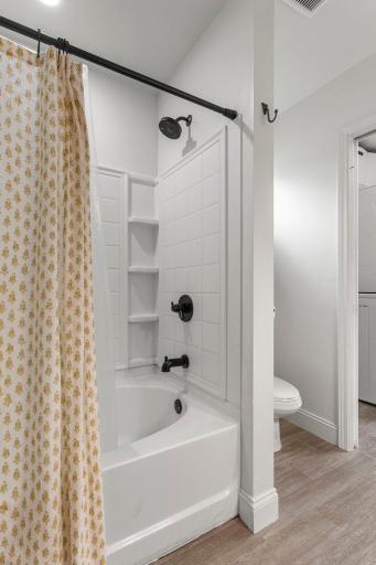 The walk-through full bathroom features a tub/shower with soaking tub.