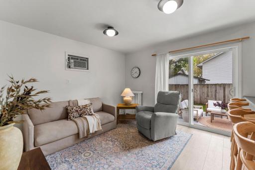 The kitchen flows effortlessly into the cozy family room featuring durable LVP flooring and direct walkout access to the backyard patio, creating excellent indoor-outdoor connectivity.