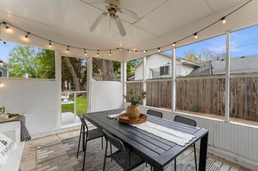 A covered screened porch with ceiling fan extends the living space and offers the perfect setting for morning coffee, summer evenings, or hosting guests.
