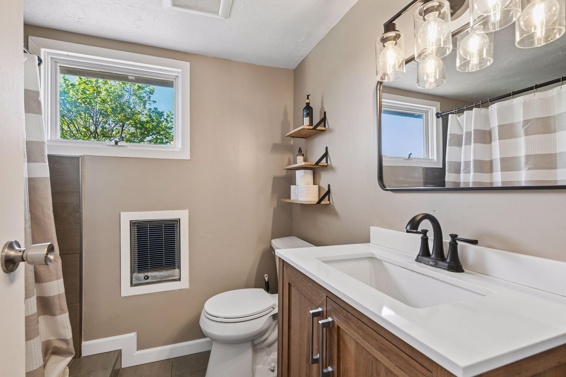 New tub, flooring, shower tile, vanity, lighting and toilet