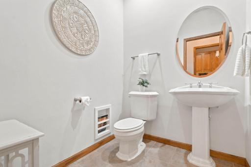 Main floor powder room is conveniently located off the mudroom.