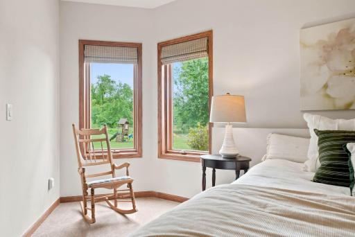 Lower level bedroom looks over the pond and acreage.