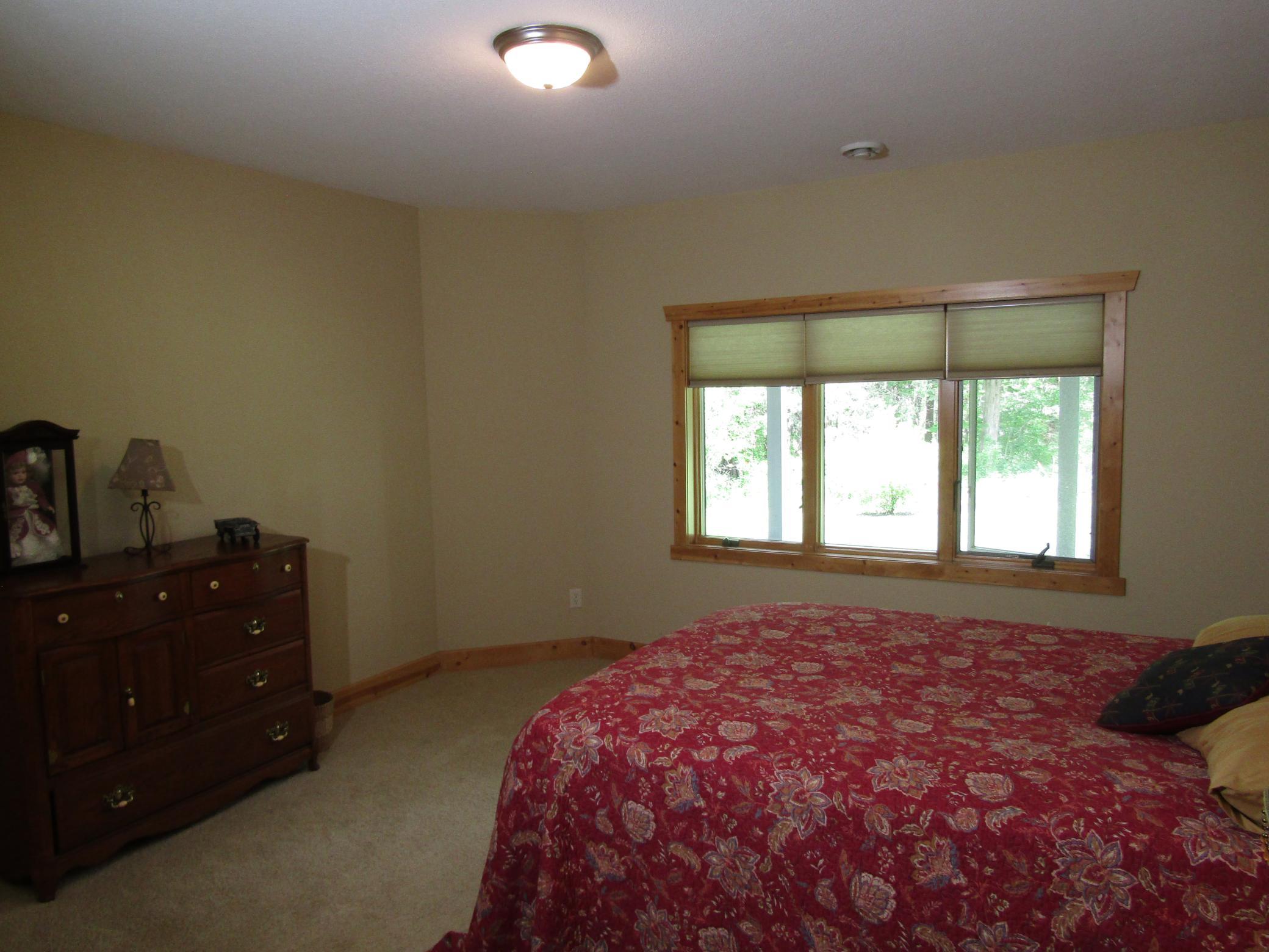 Bedroom 3 in lower- level overlooks private backyard and offers spacious closet.