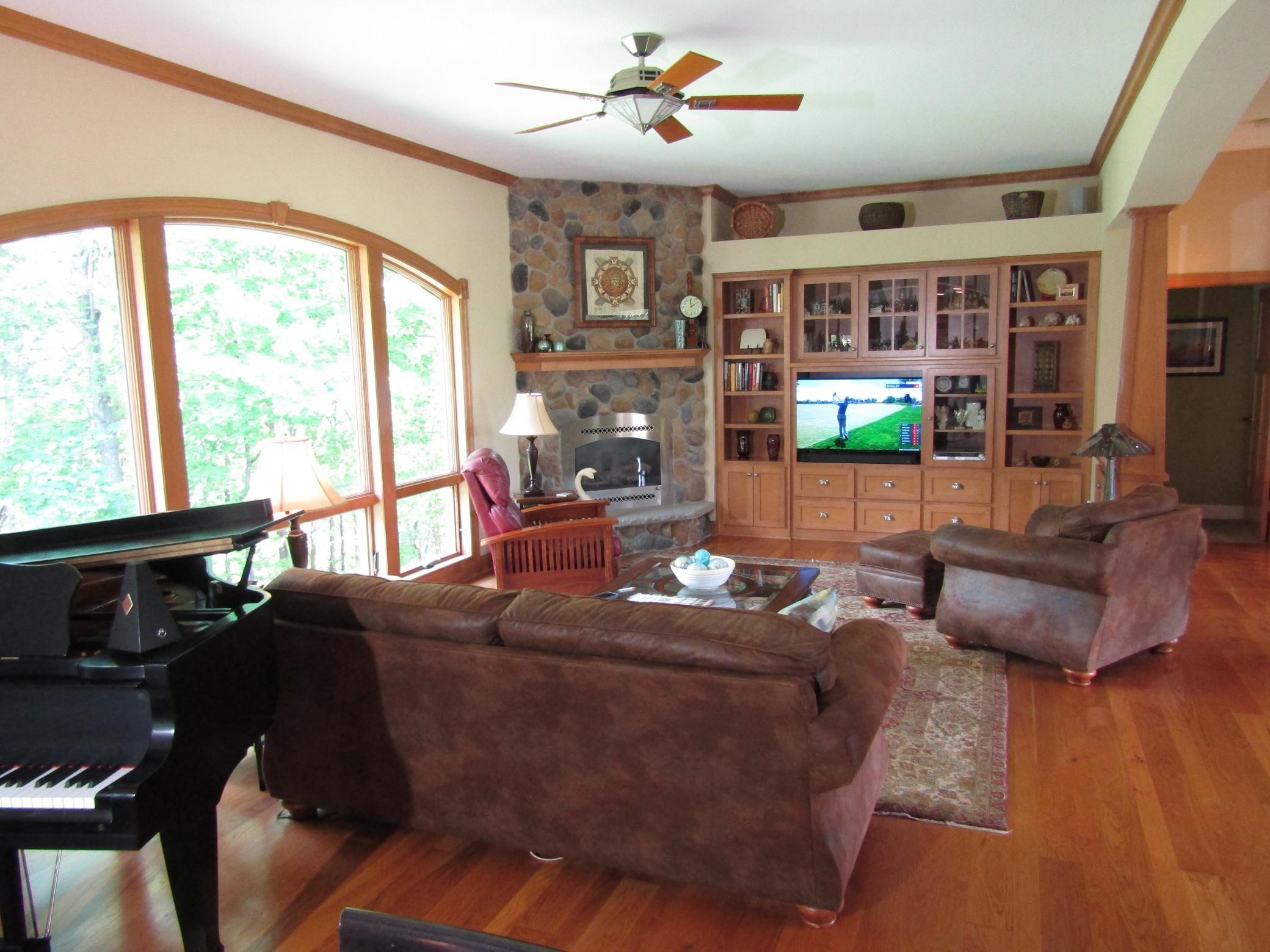 Great room with gas fireplace, cherry hardwood floors and awesome views of the backyard and Sand Creek valley.