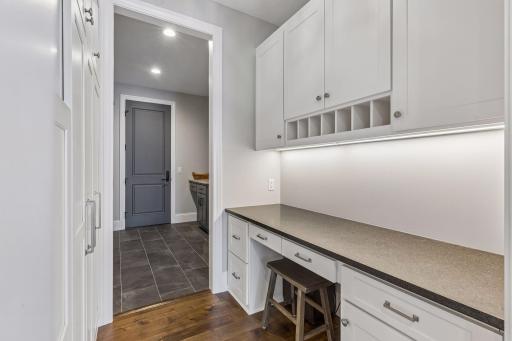 Built-in desk and pantry storage connect the kitchen and mudroom.