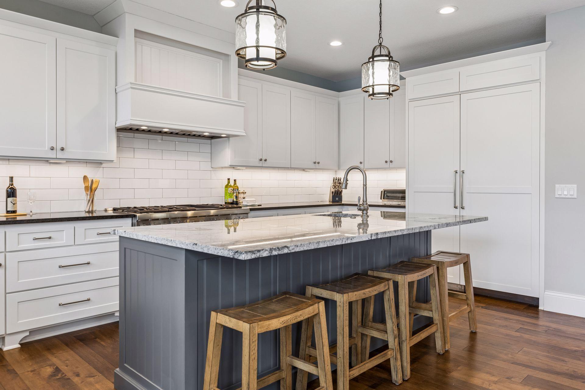 Kitchen showcases enameled cabinetry, granite countertops, subway tile backsplash, stainless steel appliances.