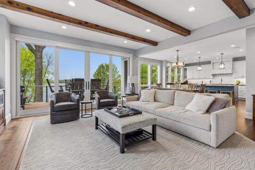 Walls of windows and direct deck access maximize the stunning lake setting.