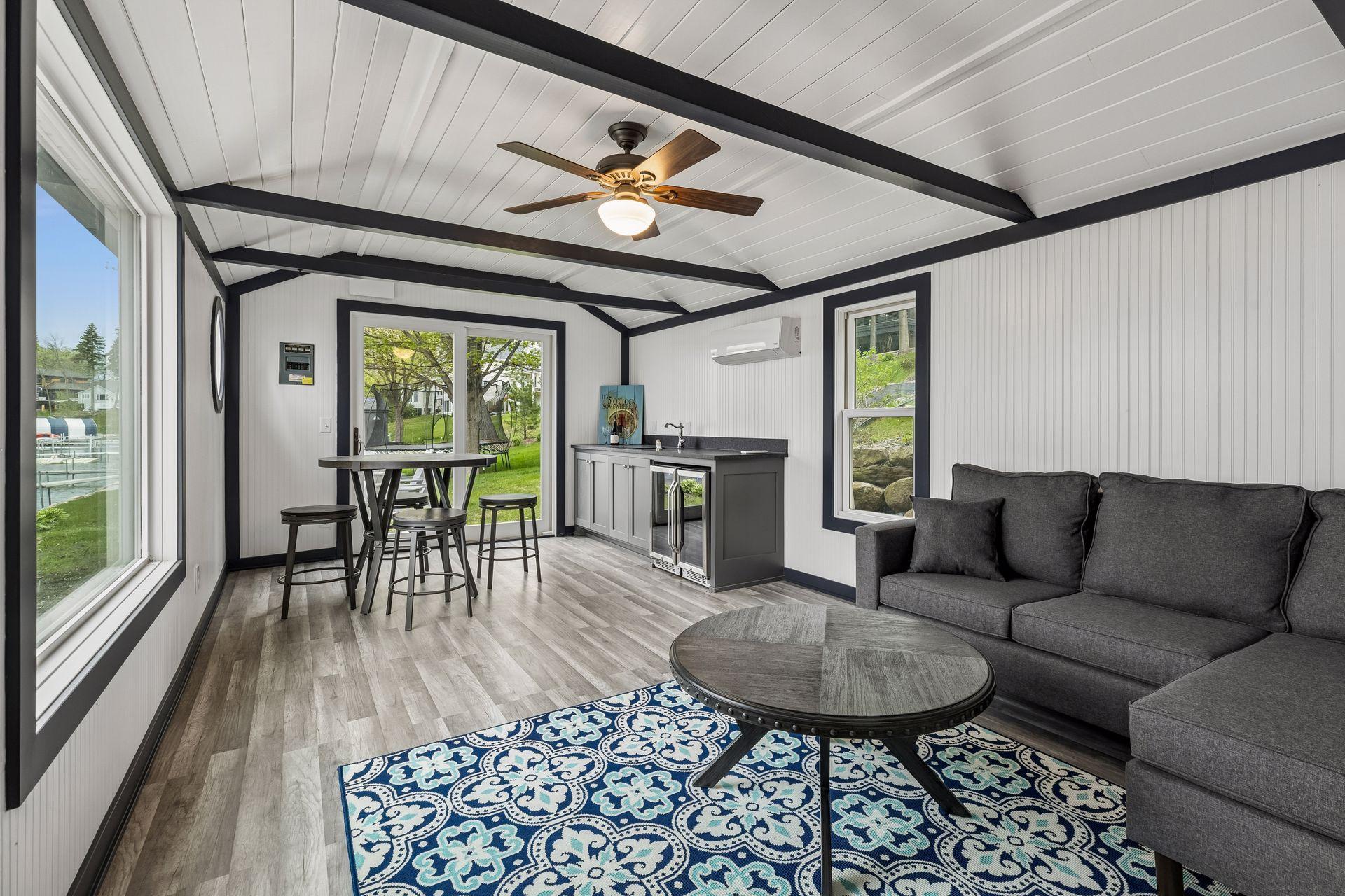 The boathouse features a comfortable sitting area, wet bar, and expansive water views.