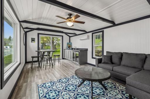 The boathouse features a comfortable sitting area, wet bar, and expansive water views.