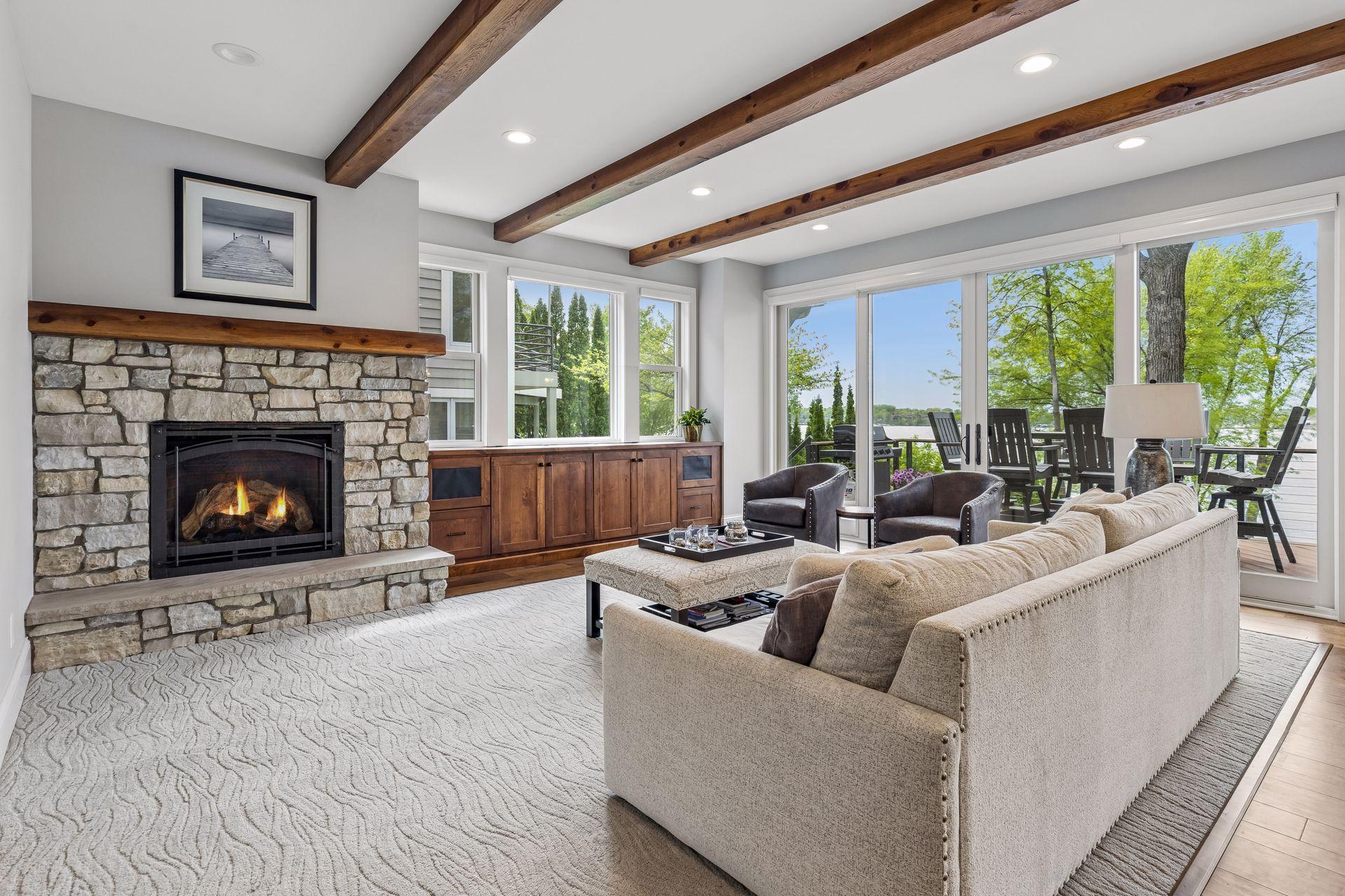 The inviting living room features a gas fireplace with stacked stone surround,