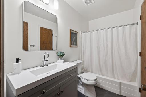 Newly refinished bathroom on mainfloor includes new flooring, new vanity, new mirror, and new paint.