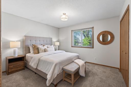 Primary bedroom on main floor with generous closet space and access to bathroom