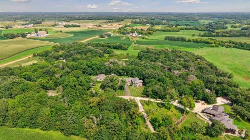 Aerial view of Cannon Woods Trail surrounded by mature trees and paved street entrance just minutes to downtown Waconia, Lake Waconia and the vibrant community which offers something for everyone!