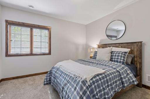 A private lower-level retreat offering comfort, tranquility, and exceptional craftsmanship. Perfect for guests or family, this spacious bedroom provides a quiet sanctuary with the elevated design and warmth expected in a luxury residence.
