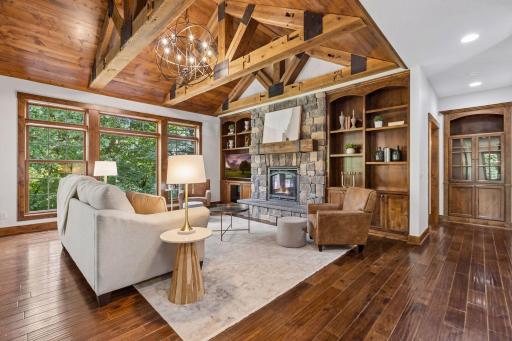 A stunning showcase of craftsmanship featuring hand-scraped walnut hardwood floors, 100 year old reclaimed Wisconsin beams, and a dramatic stacked stone gas fireplace anchoring this exceptional great room.