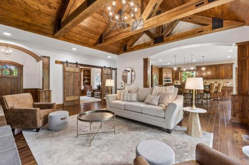 Exceptional craftsmanship shines throughout with a barrel-vaulted foyer, soaring beam trusses, graceful archways, and a private office concealed behind custom barn doors. An open layout keeps every space connected and inviting.