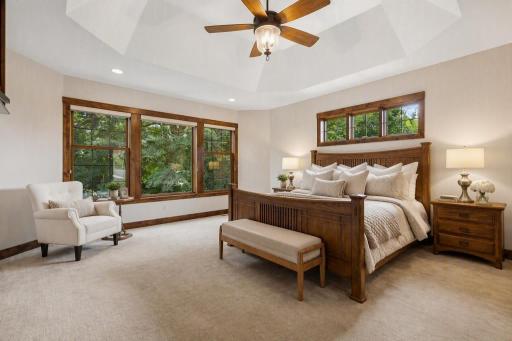 Escape to a luxurious main-level owner's retreat where tranquil wooded views, soaring ceilings, and generous proportions create a true sanctuary. A private haven designed for quiet mornings, peaceful evenings, and everyday indulgence.