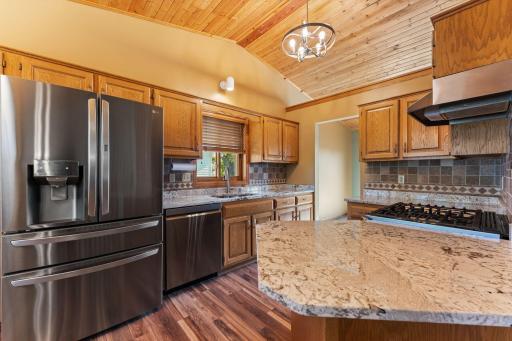 Large open kitchen with new stainless steel appliances, granite counter tops and large island