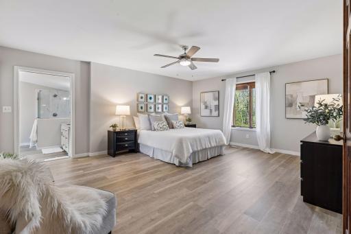 Primary owner's suite showcases peaceful lake views and a luxurious bath retreat.