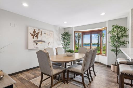 Sophisticated dining room blends timeless character with peaceful lakefront surroundings for an elevated entertaining experience.