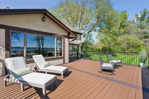 Expansive TREX decking with integrated lighting creates the perfect setting for outdoor entertaining surrounded by mature woods and abundant wildlife.