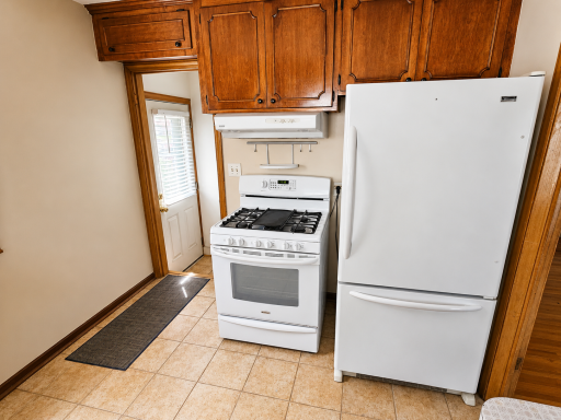Kitchen to the side entry and stairs to the lower level.