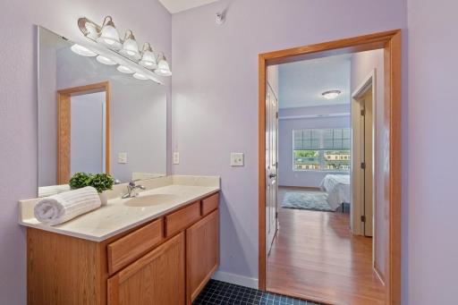 Plenty of light, a nice-sized vanity and tile flooring complete this space.
