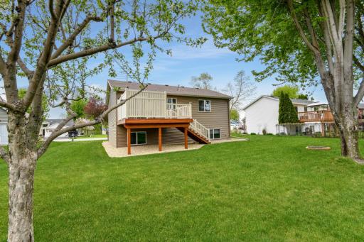 Enjoy your nicely manicured yard from a spacious deck featuring low maintenance railing or sit by the fire with family and friends