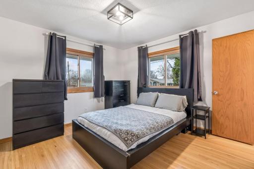 One of three main floor bedrooms - all with oak hardwood floors. The primary suite includes a half bath.