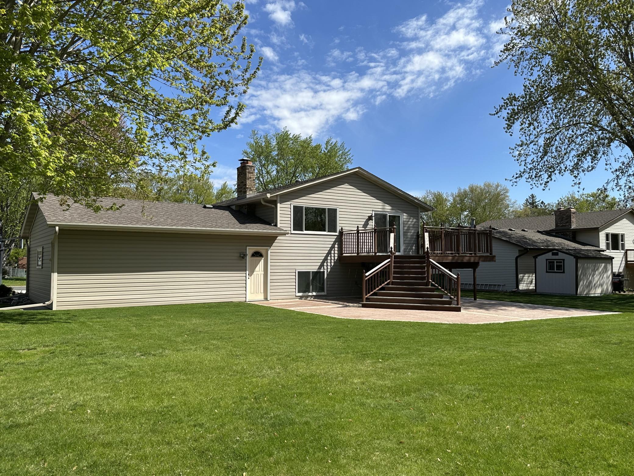 Level Immaculate Rear Yard with 30' x 34' Stamped Colored Concrete Patio and Large Redwood Deck