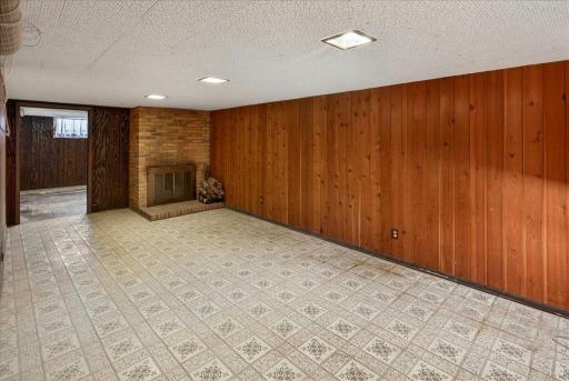 Lower level family room with wood burning fireplace