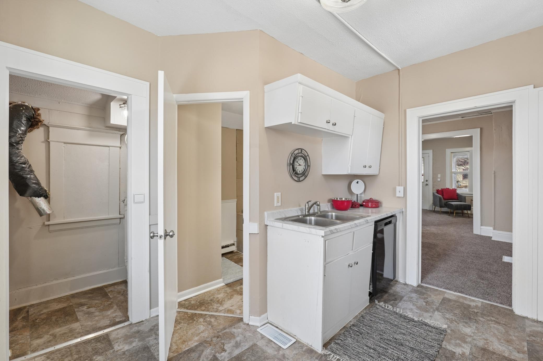 Main floor laundry area conveniently located just off the kitchen with additional storage cabinetry.